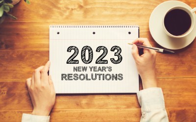 A notebook reads: 2023 New Year's Resolutions