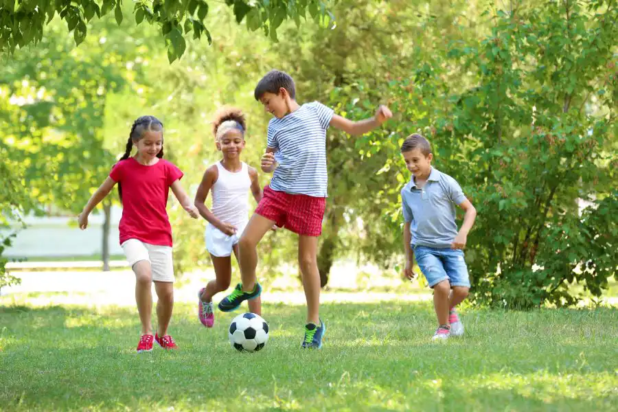 Group of children playing soccer in a field - keep pests away from your home with Arrow Exterminating Company in NY