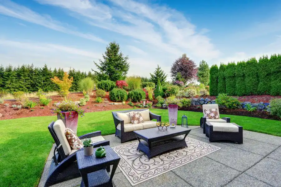 Suburban backyard with outdoor furniture and well manicured lawn - keep pests away from your home with Arrow Exterminating Company in NY